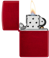 Load image into Gallery viewer, A classic Zippo-style lighter with a textured red metal body and open lid, shown lit with a visible flame against a plain white background.
