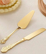 Gold cake server and knife set on a light background
