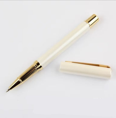 Cream-colored pen with gold accents on a white background